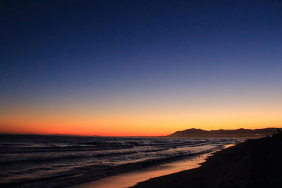 View of calm beach at sunset