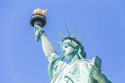 Low angle view of statue against clear blue sky