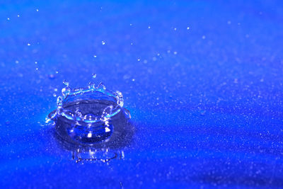 Close-up of water splashing against blue background