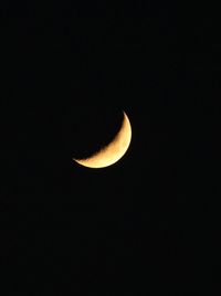 Low angle view of half moon against sky at night