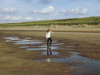 Full length of woman standing on shore