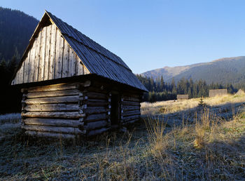 Abandoned house on field against clear sky