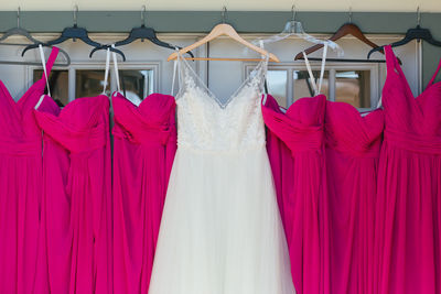 Wedding dresses hanging on wall