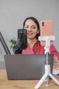 Portrait of young woman using mobile phone