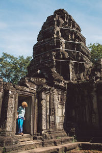 Mid adult woman standing in ankor wat temple