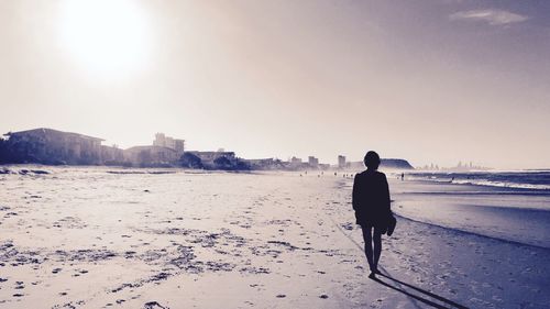 Silhouette of woman standing on beach