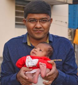 Portrait of happy boy holding baby