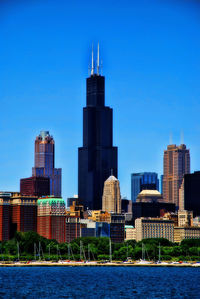 Modern buildings in city against clear sky