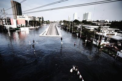 High angle view of river by city against sky