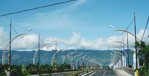 Street by road against sky