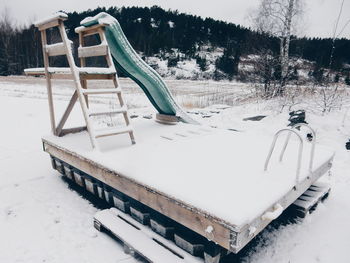 Snow covered slide at playground