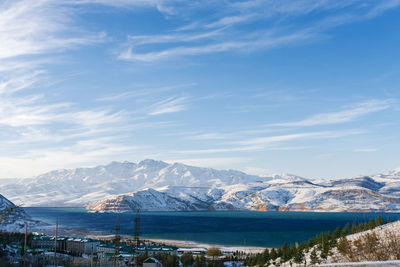 Mountain lake charvak in uzbekistan on a snowy frosty day, surrounded by the tien shan mountains.