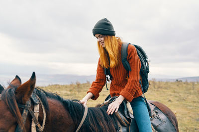 View of people riding horse on field