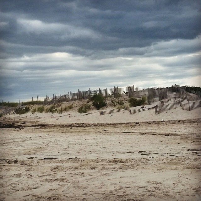 sky, landscape, tranquil scene, tranquility, cloud - sky, cloudy, nature, arid climate, sand, scenics, desert, cloud, beauty in nature, horizon over land, remote, non-urban scene, barren, day, dirt road, field