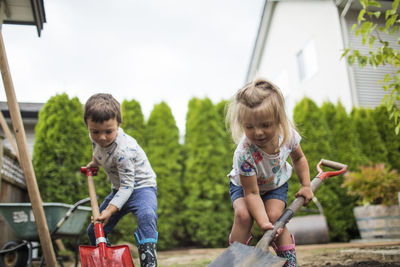 Boys and girl holding umbrella