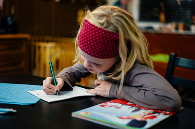 Full length of woman sitting on table
