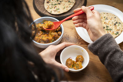 Midsection of woman eating food