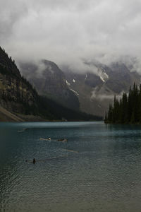 Scenic view of lake and mountains against sky