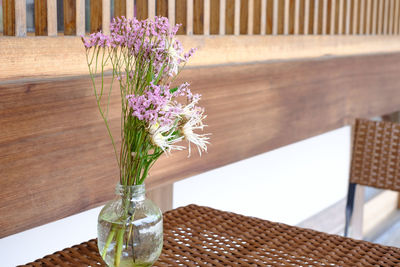 Close-up of purple flower vase on table