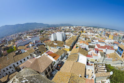 High angle view of houses in town against clear sky