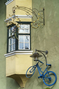 Bicycle parked against building