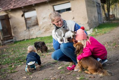 Rear view of people with dog