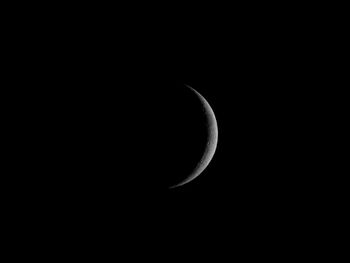 Low angle view of half moon against sky at night