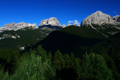 Scenic view of mountains against clear blue sky