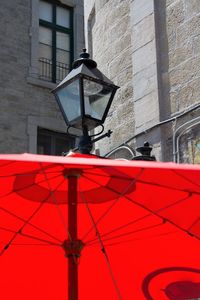 Low angle view of electric lamp on building