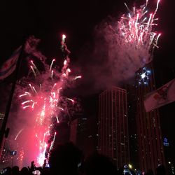 Low angle view of firework display at night