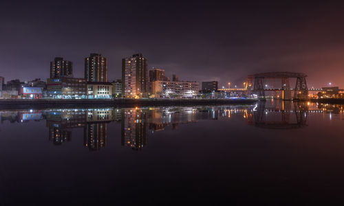 Reflection of buildings in calm river