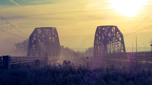 View of bridge against cloudy sky during sunset