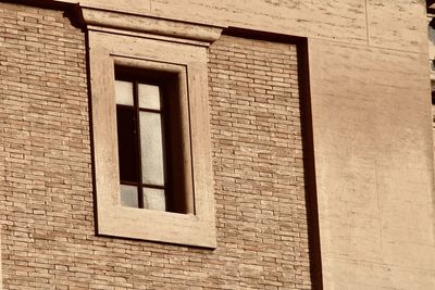 Low angle view of window on wall of building