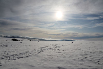 Scenic view of snowcapped mountains against sky during winter