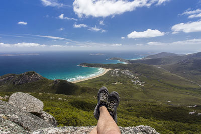 Scenic view of sea and mountains against sky