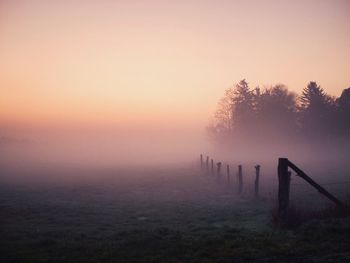 Scenic view of field against sky during sunset