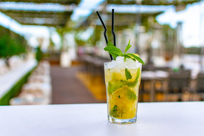 Close-up alcoholic mojito tropical cocktail drink on table