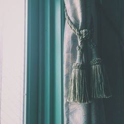 Close-up of curtain by window at home