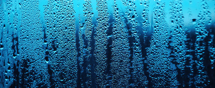 Texture of misted glass in autumn. drops of water on window in rainy weather. abstract background