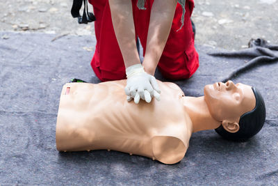 Low section of man lying on road