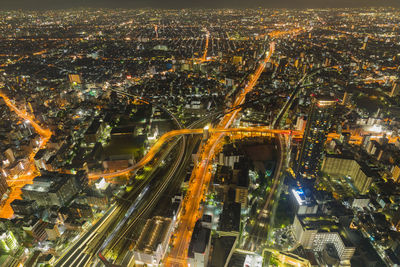 High angle view of city lit up at night