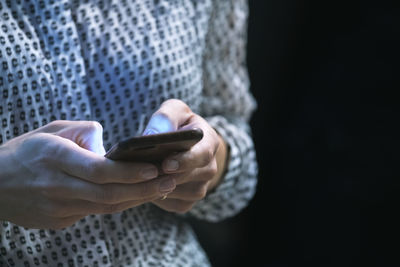 Midsection of woman using mobile phone