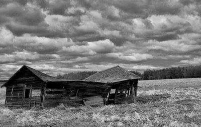 Abandoned barn on field against sky