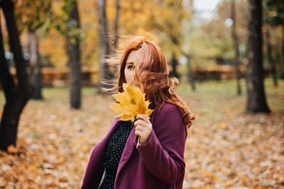 Autumn fashion, earth tones style, bright fall color palette. portrait of red-haired girl in purple