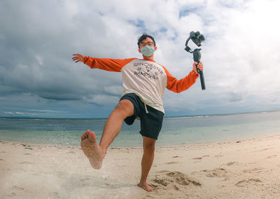 Full length of man on beach against sky