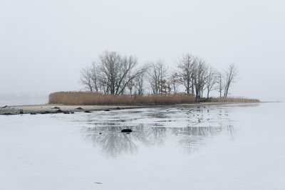 Scenic view of frozen lake against sky during winter
