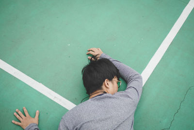 High angle view of man lying on court