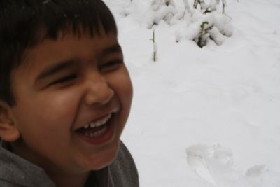 Portrait of boy smiling in snow