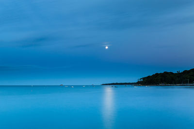 Scenic view of sea against blue sky