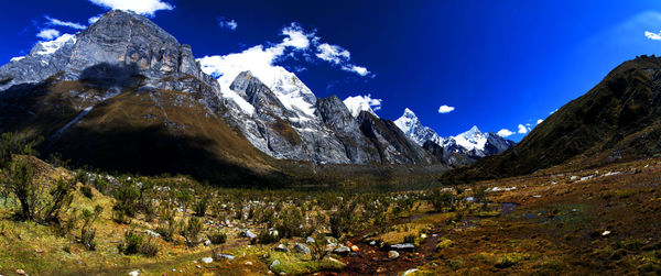 Panorama of snowy mountains and valley in the remote cordillera huayhuash circuit in peru.